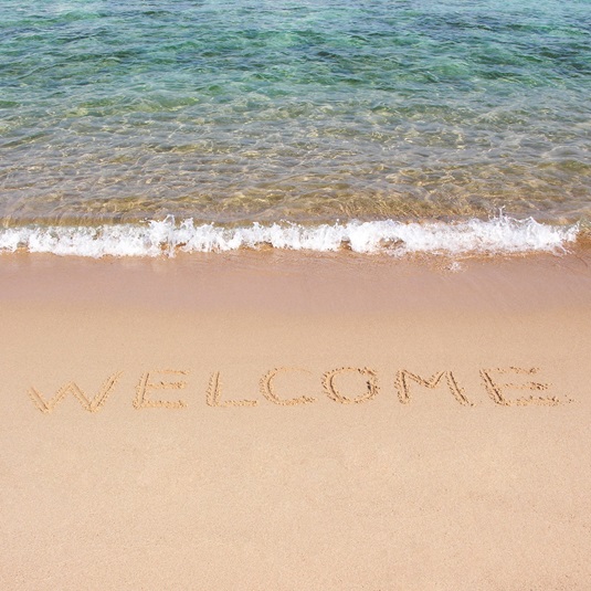 Welcome Willkomen Sand Foto lizenzfrei